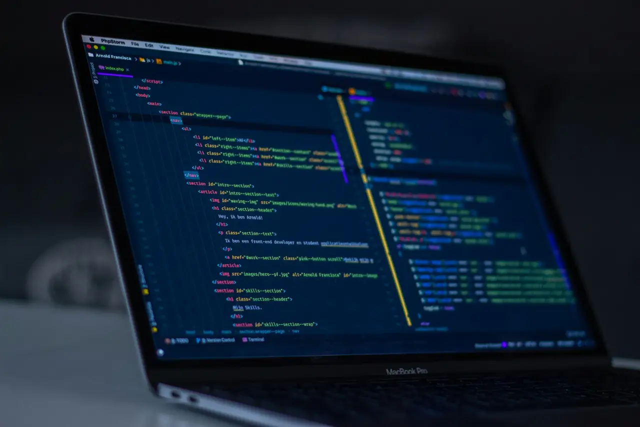 A close view of program code on a dark monitor.